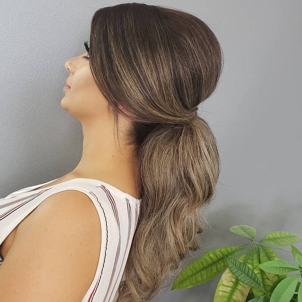 Updo Ponytail with Highlights - A woman wearing a stripe sleeveless blouse