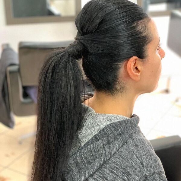 Upstyle Ponytail - A woman wearing a gray jacket