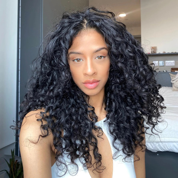Voluminous Finger Coils Natural Hairstyles for Women - a woman wearing a white dress