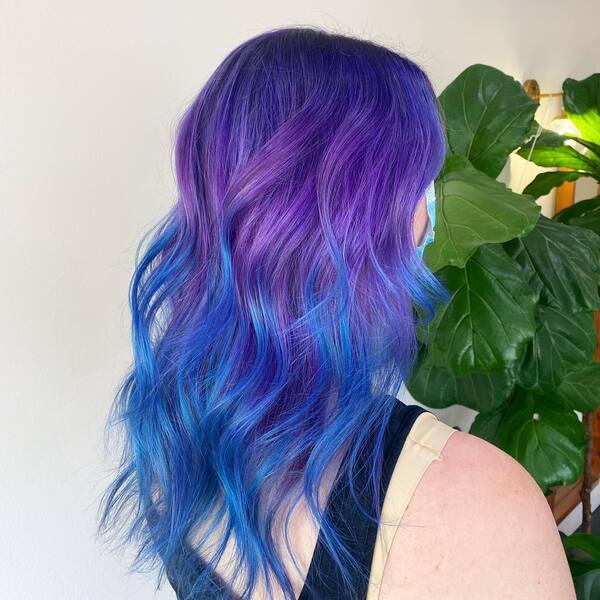 Wavy Ariel Blue & Purple Galaxy Hair Color Style - a woman in a back view