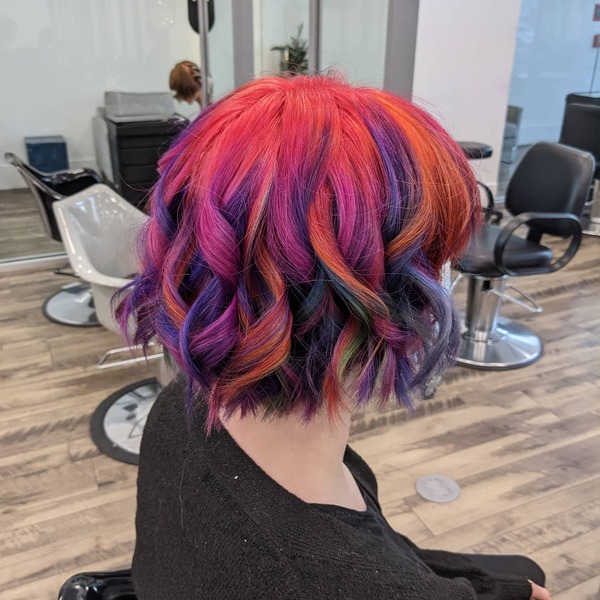 Wavy Bob Cut Rainbow Hair - A woman inside a salon