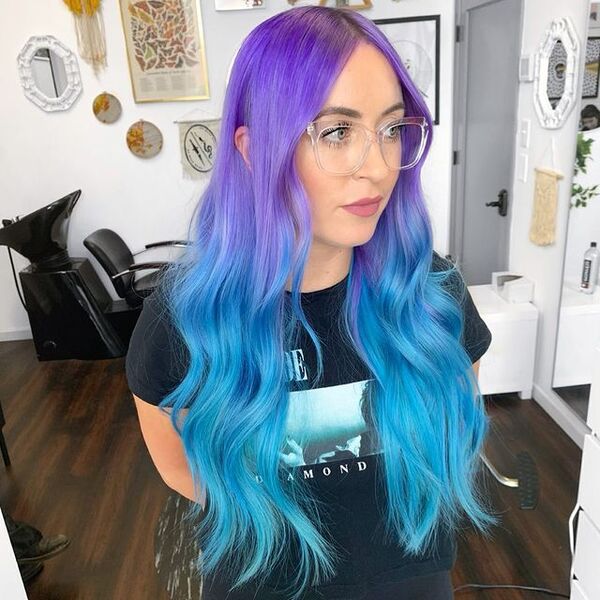 Wavy Electric Blue & Purple Hair Color - a woman wearing an eyeglasses