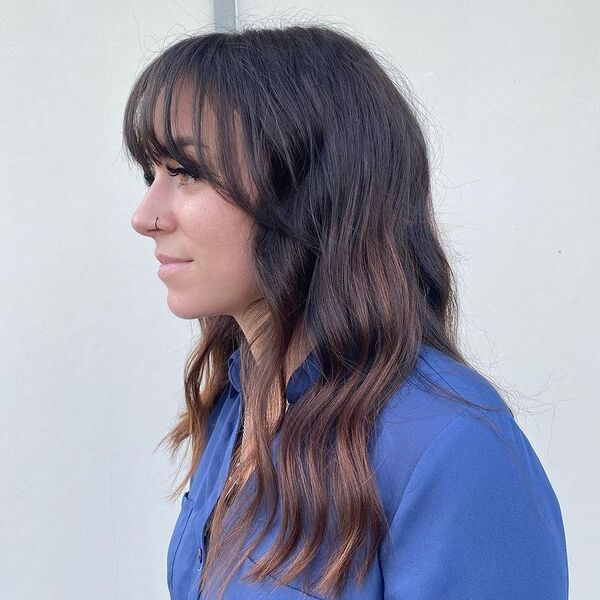 Wavy Hair with Wispy Bangs - a woman in a side view