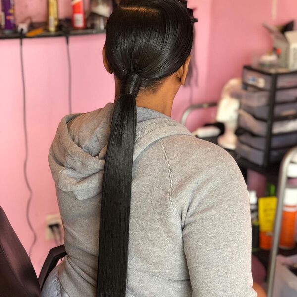 Weave Ponytail - A woman wearing a gray hooded jacket