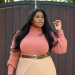 50 Flattering Haircuts for Plus Size Women in 2022 - a woman wearing a peach dress