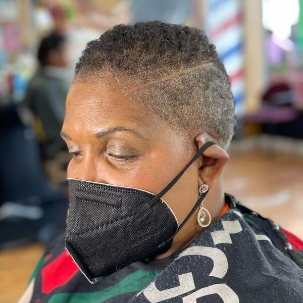 Afro Super Short Haircut - a woman wearing a black face mask