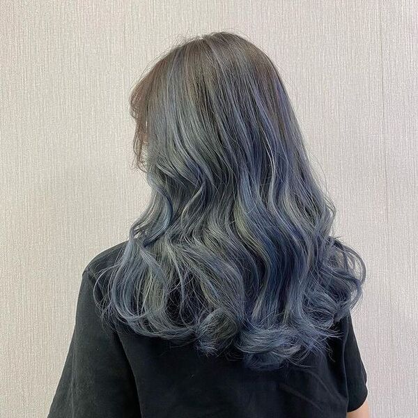 Ashy Blue Highlights for Wavy Hair - a woman in a back view