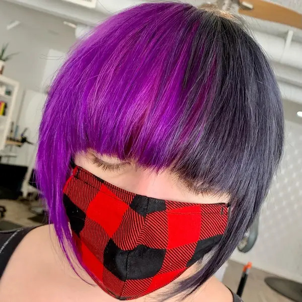 Asymmetrical Bob with Purple Black Half-and-Half - a woman wearing a red face mask