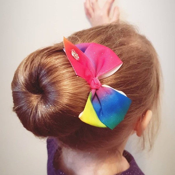 Ballerina Bun with Rainbow Ribbon - a girl in a back view