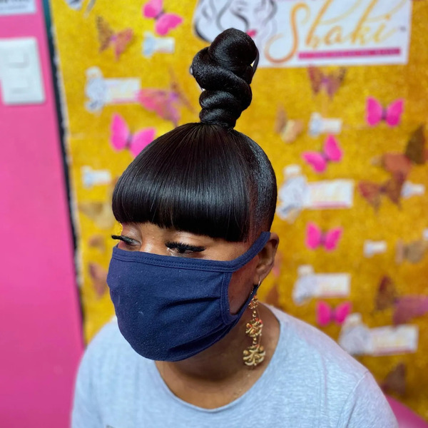 Bangs with Knotbun for Baddie Hairstyle  - a woman wearing a blue face mask