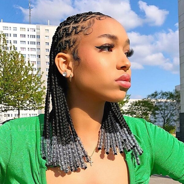 Beautiful Transparent Beads in Lemonade Braids - a woman wearing a green dress