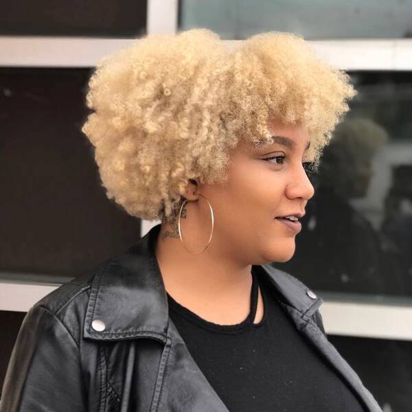 Blonde Fro Hairstyle - a woman wearing a leathered jacket