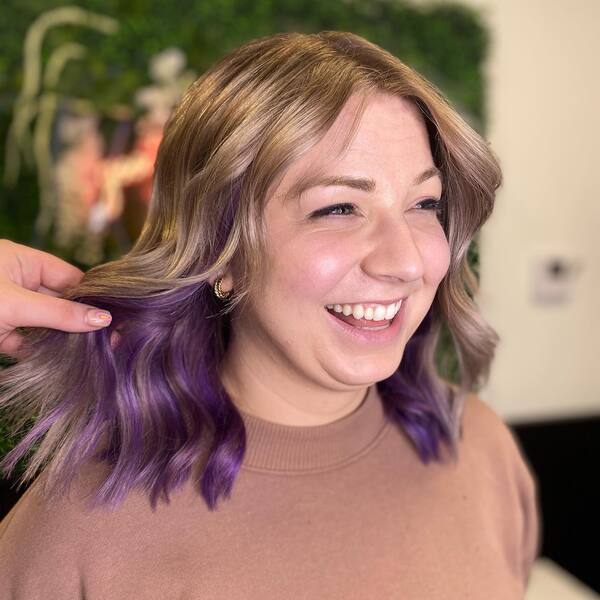 Blonde Hair with Smokey Violet Underlights - a woman wearing a brown shirt