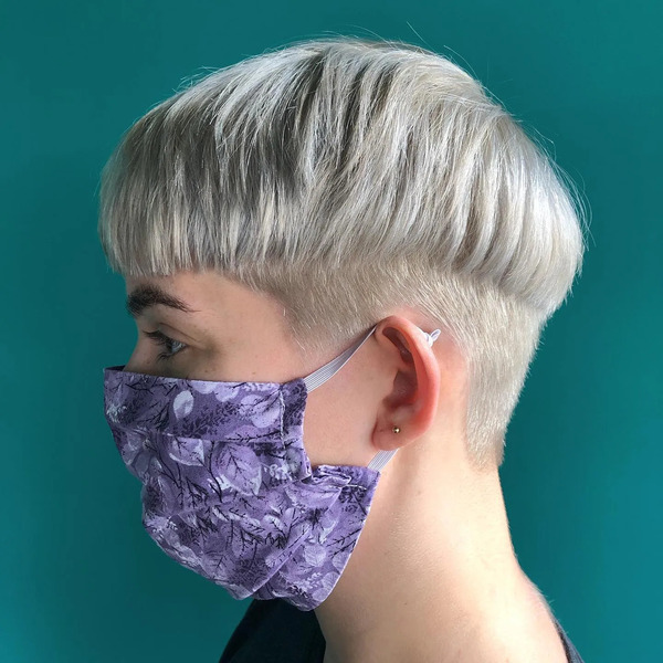 Blonde Mushroom Cut - a woman wearing a face mask