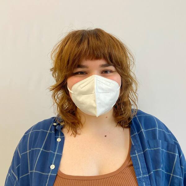 Honey Blonde Shag Haircut - a woman wearing a face mask