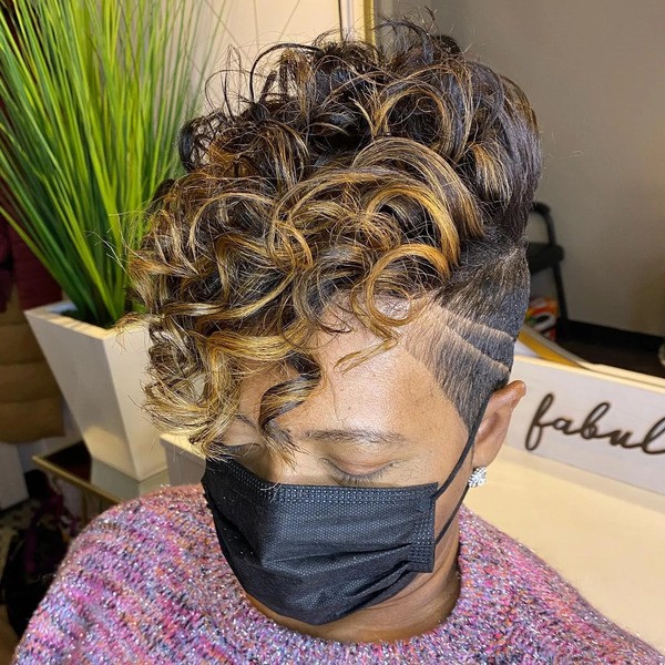 Blonde Tones with Poppin Curls and Undercut - a woman wearing a black face mask