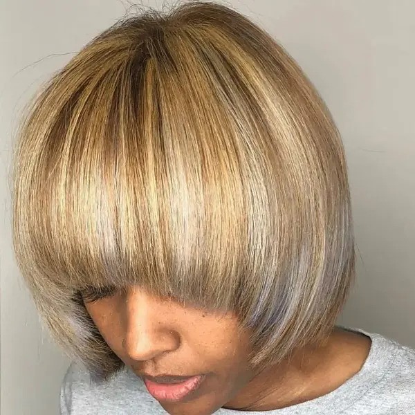 Blonde and Concave Bob Hairstyle - a woman wearing a gray shirt