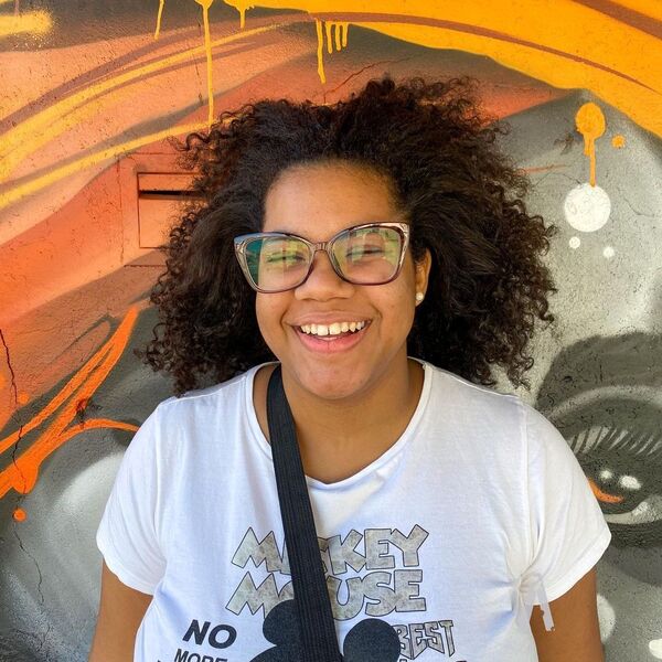 Blown-Away Afro Hairstyle - a woman wearing a white shirt