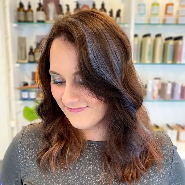 Blue Charm Highlights on Brown Hair - a woman wearing a gray shirt