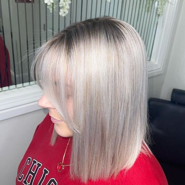 Blunt Bob with Highlights and Light Grey Toner - a woman in a top view