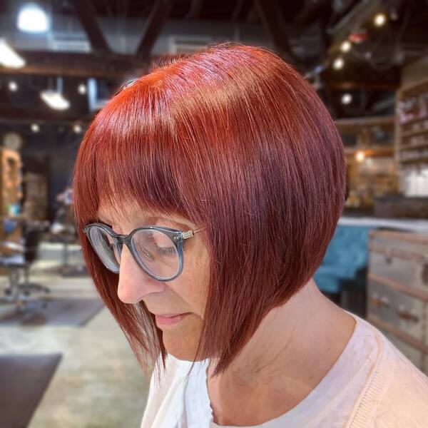 Blunt and Fabulous Red Hair - a woman wearing an eyeglasses
