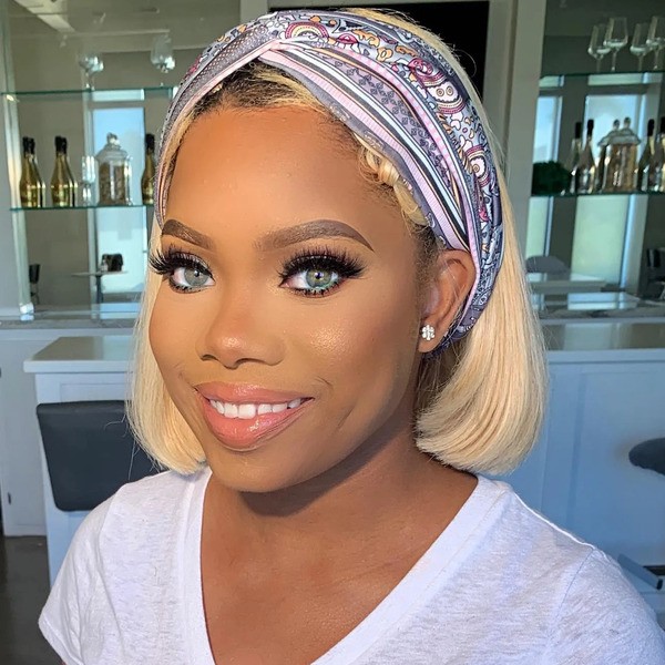 Bob Cut Blonde with Headband Style - a woman wearing a white shirt