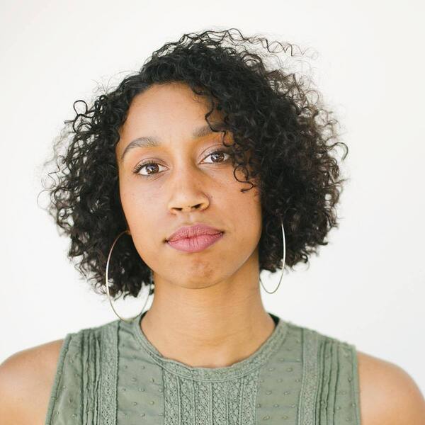 Short Bob Haircut and Soft Curls - a woman wearing a dress