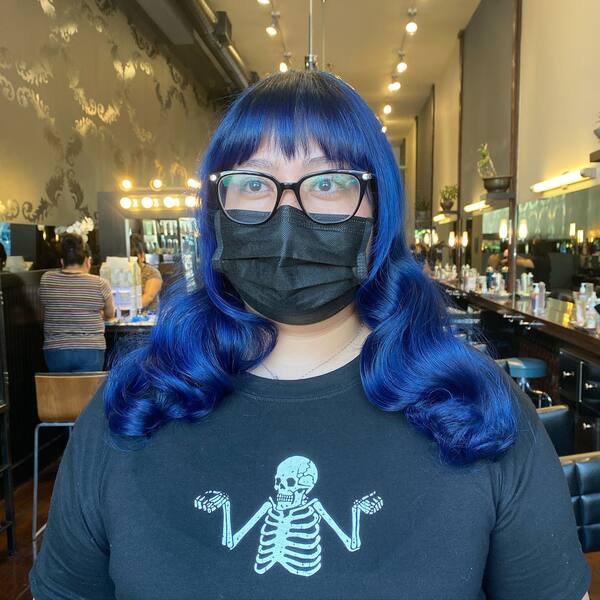 Bold and Wavy Shining Blueberry - a woman wearing a black face mask