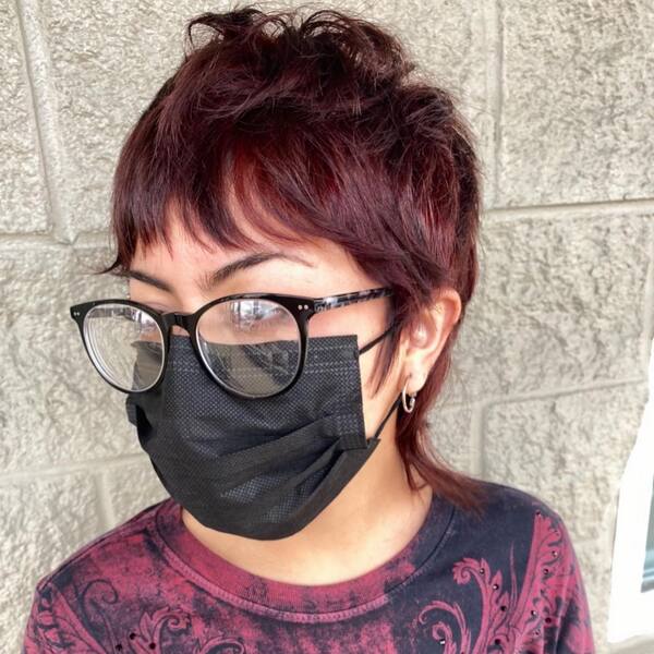 Burgundy Mullet Haircut - a woman wearing a black face mask