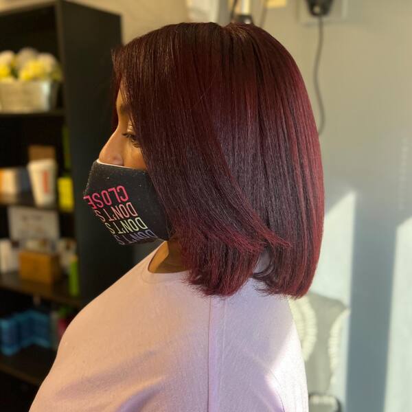 Burgundy and Simple Bob Cut - a woman wearing a face mask