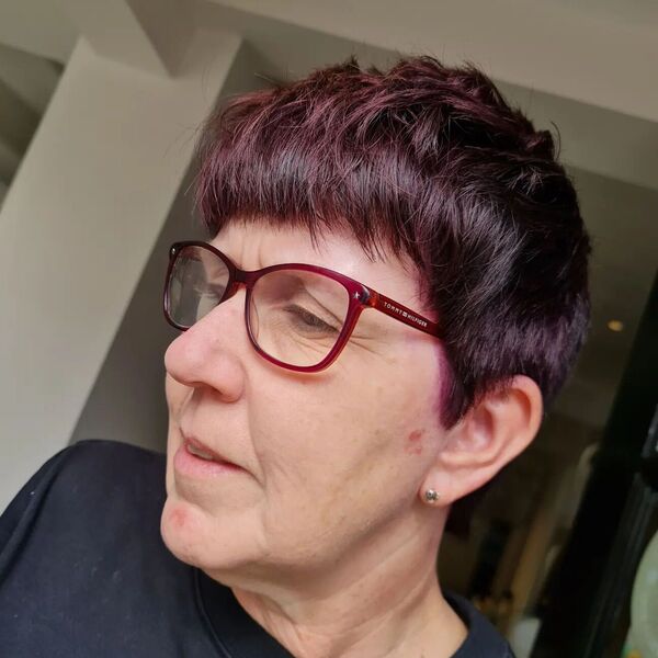 Choppy Textured Pixie Cut with Undercut Fringe - a woman wearing an eyeglasses