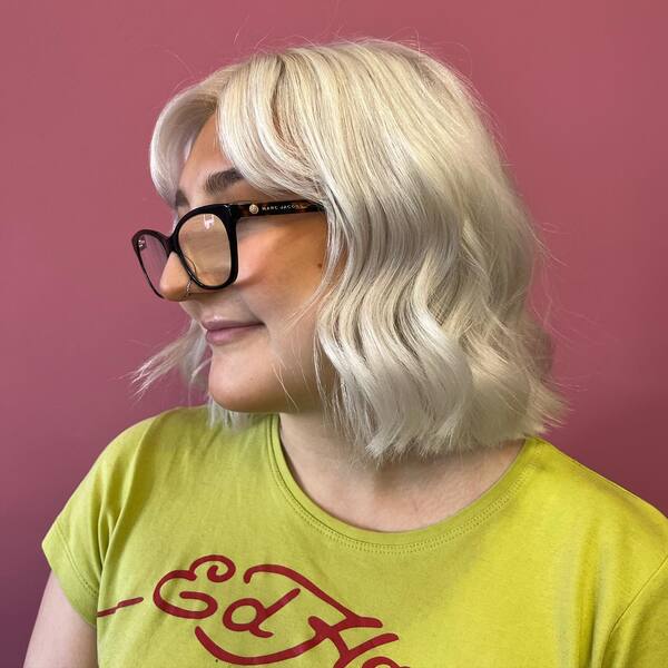 Clean Blonde in Wavy Bob - a woman wearing an eyeglasses