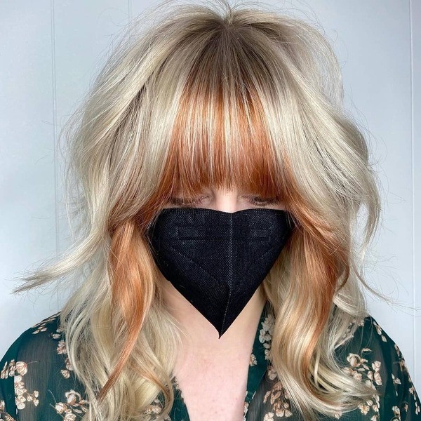 Copper Pops in Blonde Hair - a woman wearing a black face mask