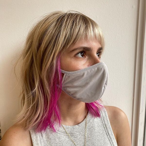 Creamy Blonde Modern Shag with Pink Pop Color - a woman wearing a face mask