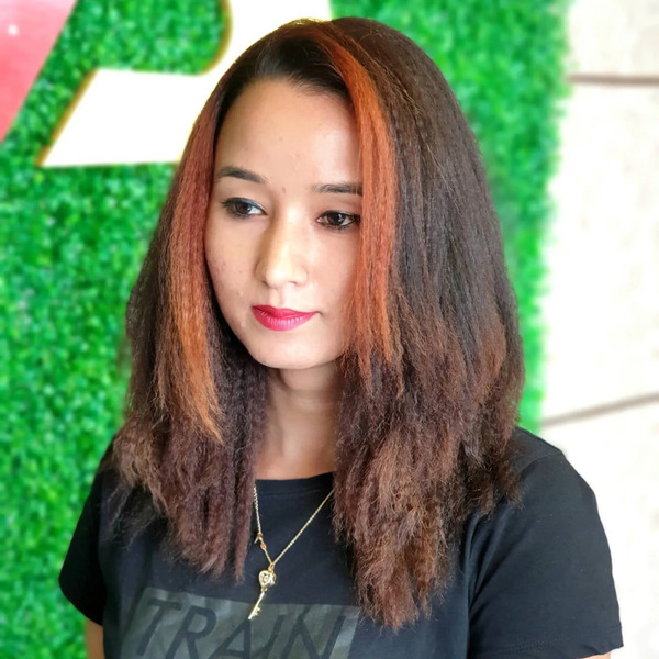 Crimped Hairstyle with Copper Highlights - a woman wearing a black shirt