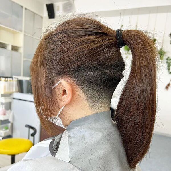 Curtain Fringe and Pony Tail with Undercut - a woman in a side view