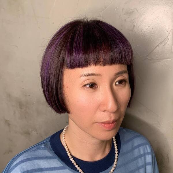 Cute Bob Haircut with Purple Highlights - a woman wearing a blue shirt