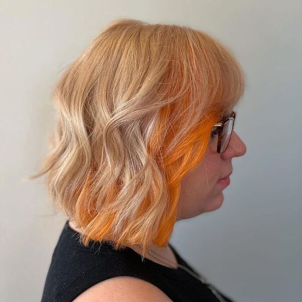 Full Bleached and Tone with a Pop of Copper - a woman wearing a black sleeveless