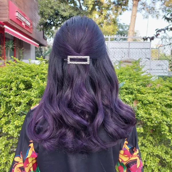 Grape Balayage in Wavy Hair - a woman in a back view