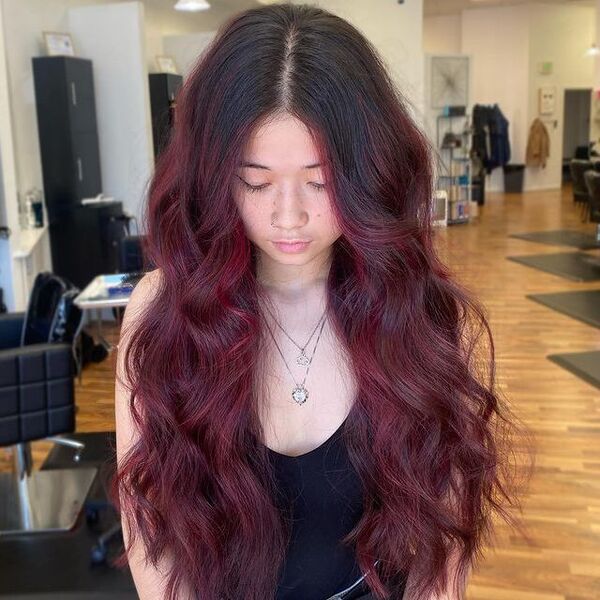 Half-and-Half Burgundy Balayage - a woman wearing a sleeveless shirt