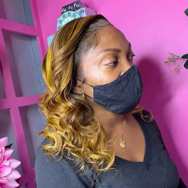 Honey Blonde and Curls - a woman wearing a face mask