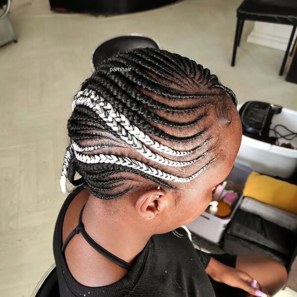 Lemonade Braids with Streaks of White Blonde - a woman wearing a black dress