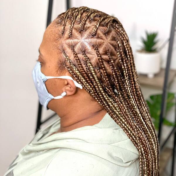 Lemonade Braids with Triangular Style - a woman wearing a face mask