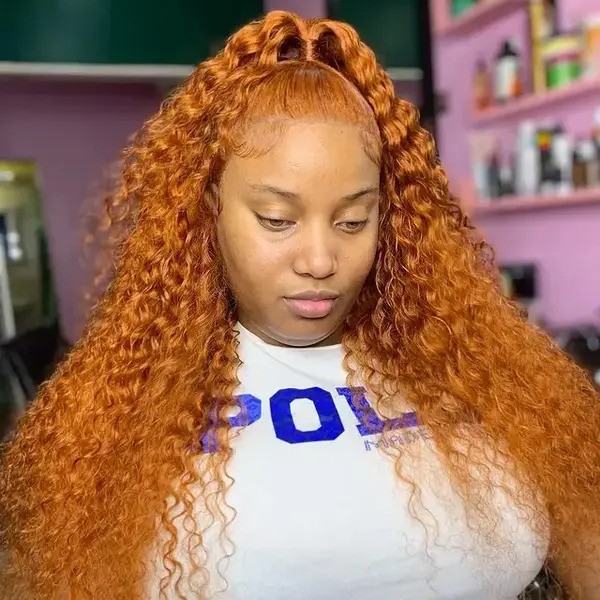 Light Reddish Blonde in Voluminous Curls - a woman wearing a white shirt