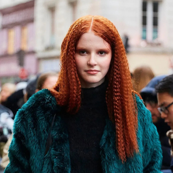 Long Crimped Red Hair - a woman wearing a fur jacket