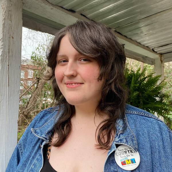 longer fringe shag - a woman wearing a denim jacket