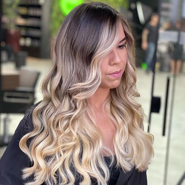 Long Wavy Black to Blonde Ombre Hair - a woman in a side view