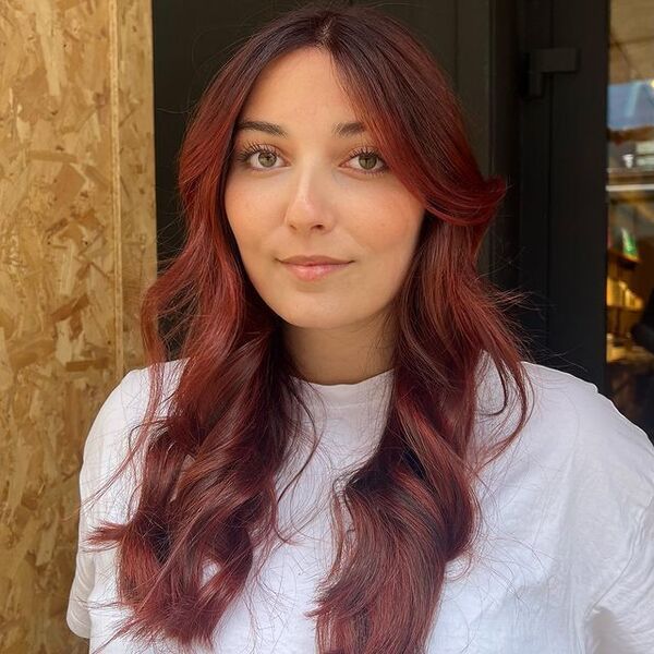 Mahogany Burgundy Hairstyle - a woman wearing a white shirt