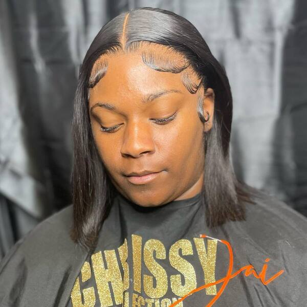 Medium Bob Cut with Baby Hairs in Finger Waves - a woman wearing a black cape