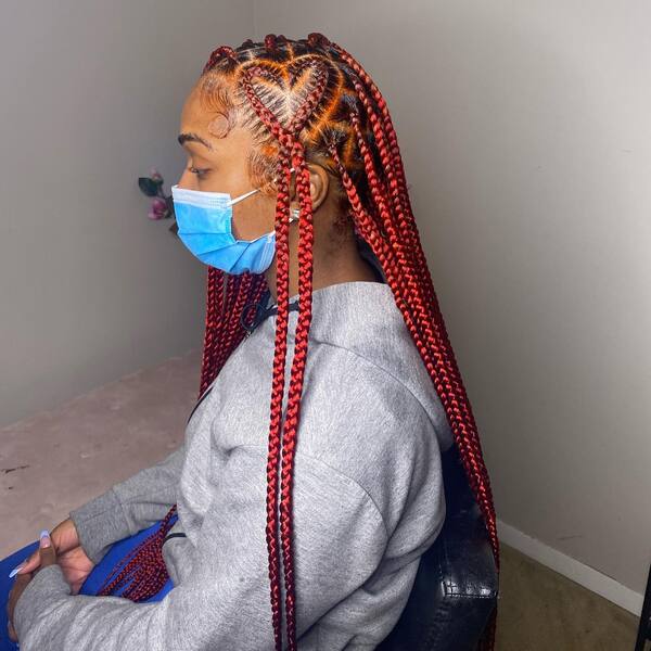 Medium Heart Style Braids - a woman wearing a face mask